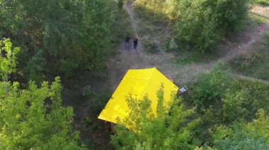 Budget glamping for family outdoor recreation. Glamping terrace in the forest. Glamping houses, rural landscape, tent houses.