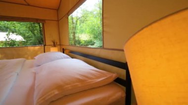 Budget glamping for family outdoor recreation. Glamping terrace in the forest. Glamping houses, rural landscape, tent houses.