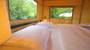 Budget glamping for family outdoor recreation. Glamping terrace in the forest. Glamping houses, rural landscape, tent houses.