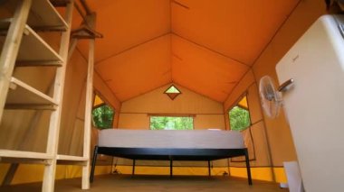 Budget glamping for family outdoor recreation. Glamping terrace in the forest. Glamping houses, rural landscape, tent houses.