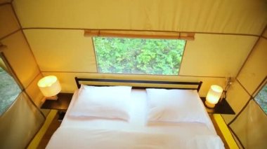 Budget glamping for family outdoor recreation. Glamping terrace in the forest. Glamping houses, rural landscape, tent houses.