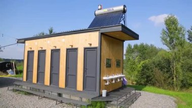 MOGYLIVKA, UKRAINE - AUGUST 21, 2022: Budget glamping for family outdoor recreation. Glamping terrace in the forest. Cute fabric tents, in a forest environment in an eco camp - editorial footage