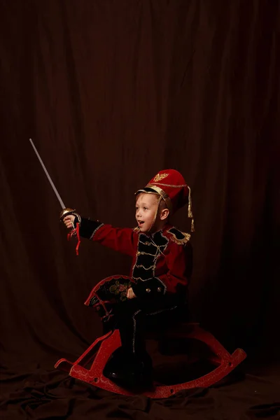 Niño Con Traje Cascanueces Caballo Juguete Con Sable —  Fotos de Stock