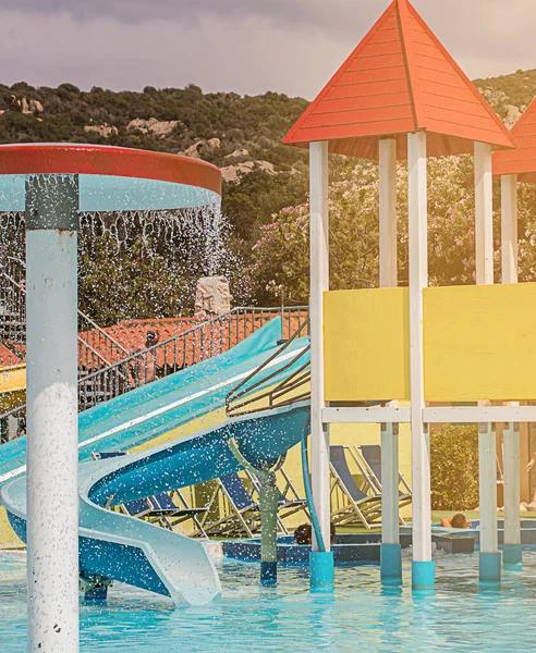 Water park with colorful slides and pools in summer