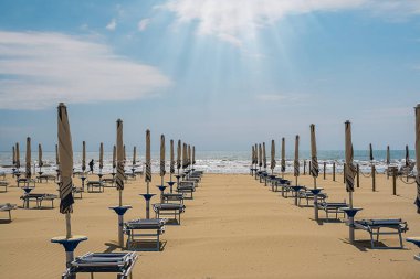 Şemsiyeler ve güneşlikler İtalya sahillerinde. Plaj sezonu açılmaya hazır..
