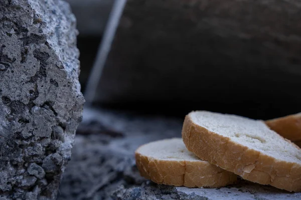 dried white bread stands on a stone surface outside on the street