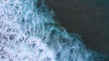 Beautiful texture of big power dark ocean waves with white wash. Aerial top view footage of ocean waves.