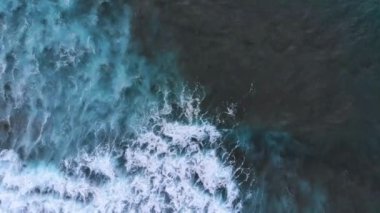 Beautiful texture of big power dark ocean waves with white wash. Aerial top view footage of ocean waves.