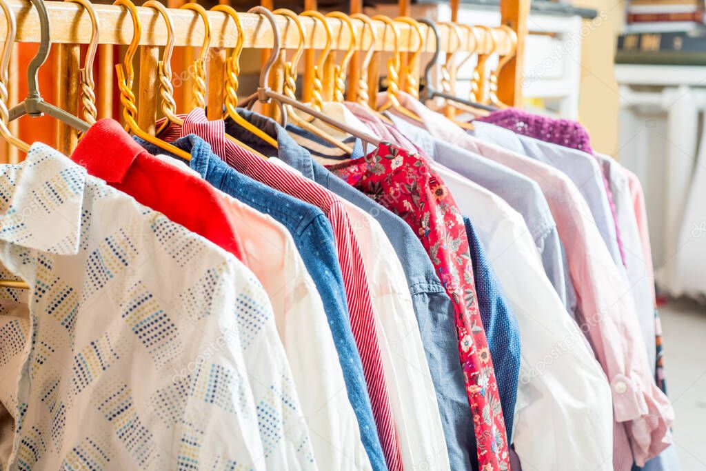 Clothes are hanging on hangers. Lots of clothes for sorting things in the wardrobe.