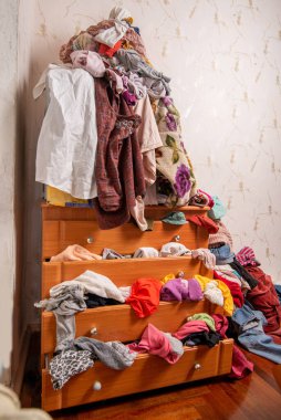 Dolapta ve evin içinde bir sürü kıyafet var. Dağınık konut