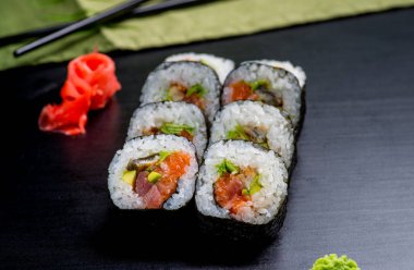 Japon suşisi ve siyah bir arka planda rulo