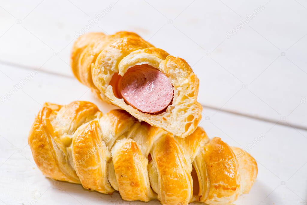 sausage in the dough, hot dog. Fresh pastries on a white background