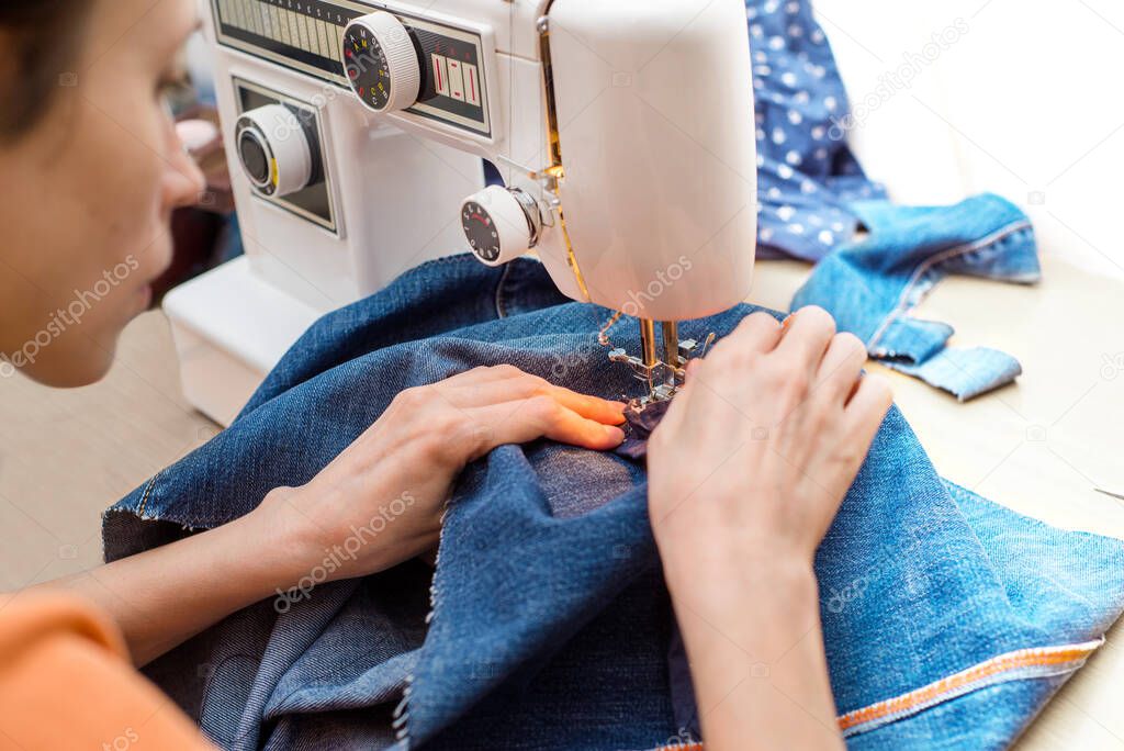 Sustainable living and fashion. A woman is altering second-hand. Waste-free living and reuse