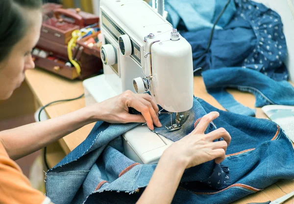 Sustainable living and fashion. A woman is sewing second-hand. Waste-free living and reuse