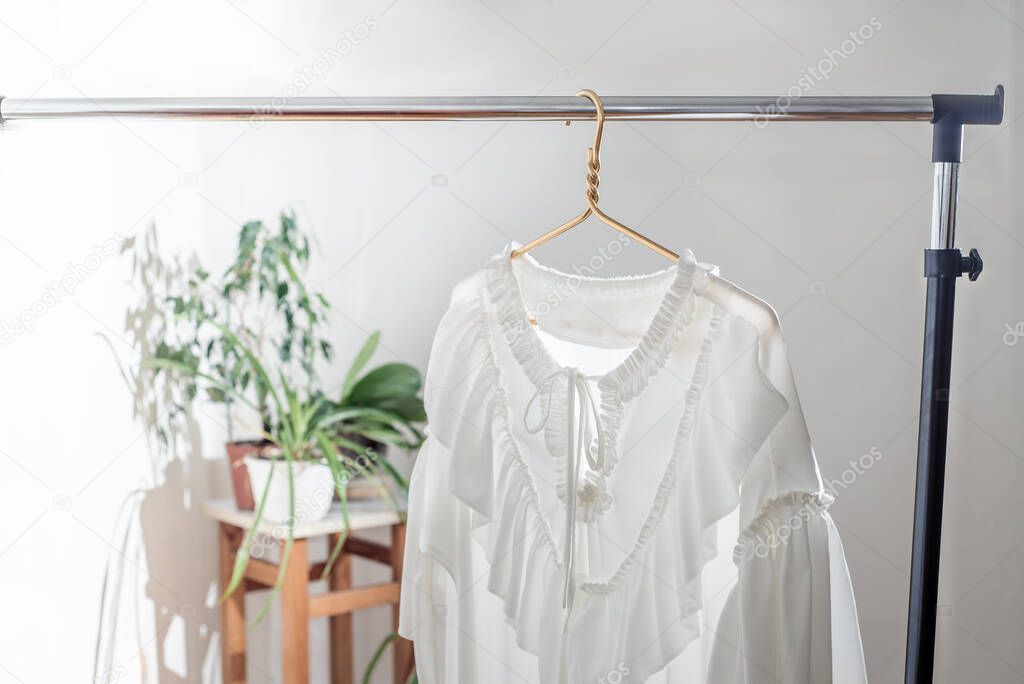 One dress on a hanger on the rail. Minimalist wardrobe. The concept of sustainable economic life. Only one clothes