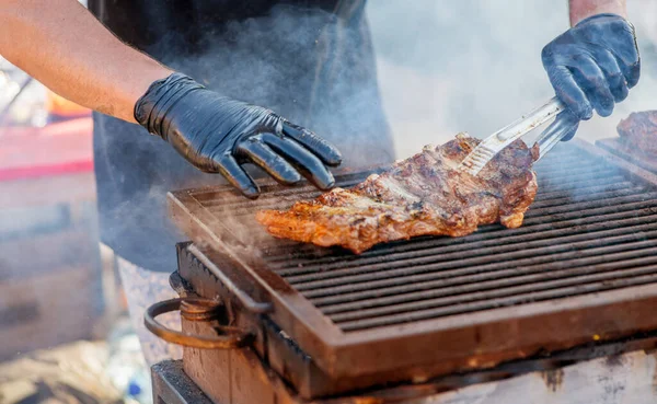 烧烤排骨 戴手套的人在炭烤架上烤排骨 全家度假的时候 在后院野餐 烧烤肉 — 图库照片