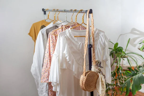 Second-hand clothes  on the rail. The concept of sustainable economic life. Sale of clothes. Summer women\'s clothing on the swap. Clothing store