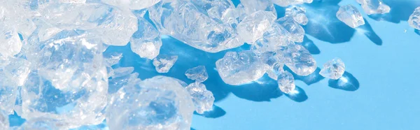 Close up crushed ice in sunlight on blue. Summer background refreshment concept — Stock Photo, Image