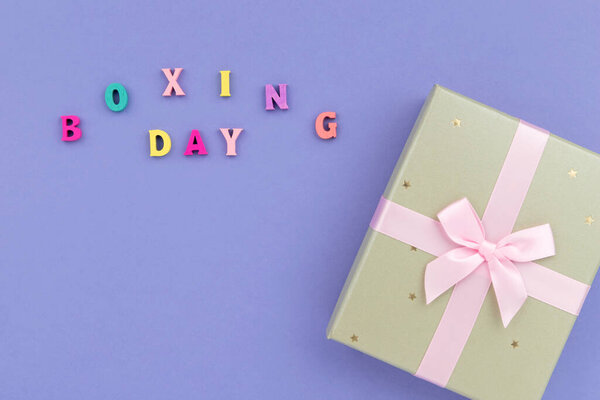 Inscription boxing day in wooden letters on purple background