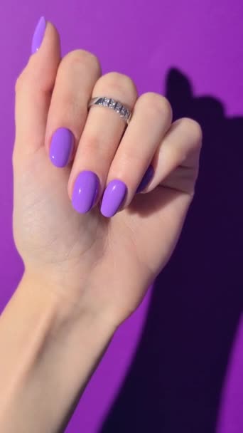 Womans hand with trendy purple manicure. Beauty treatment spa body care concept — Stock Video