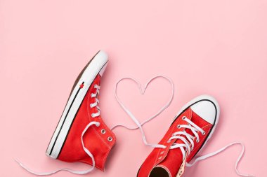 Pembe arka planda kırmızı spor ayakkabılı en düşük kompozisyon