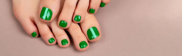 Womans feet with green nail polish on brown background — Foto Stock