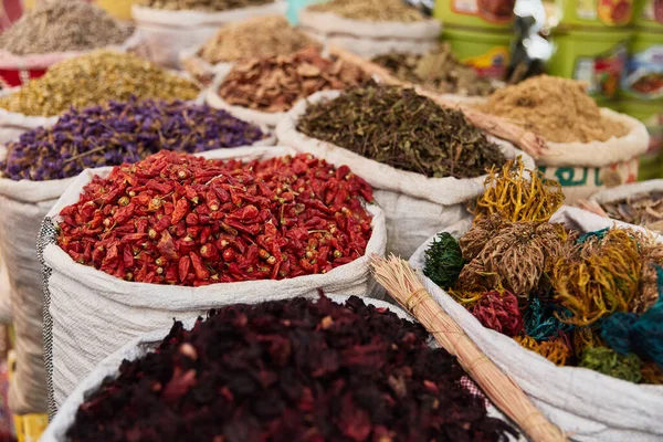 Variety organic pepper, flowers, hibiscus, herbs in sacks on sale on a farmers market.Traditional arabic market. — Stock Photo, Image