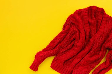 Womens red sweater on yellow background. Flat lay top view shopping sale fashion mock up.