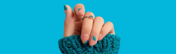 Womans hand with blue manicure. Trendy winter autumn nail design. Beauty treatment concept