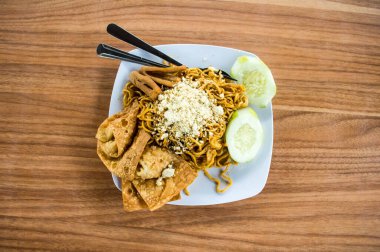 Noodle with Crackers Served on a White Plate on Top of Wooden Table