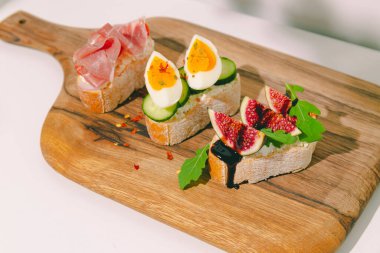 Krem peynirli, jambonlu, incirli ve yumurtalı sandviç. Yüksek kalite fotoğraf