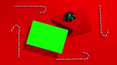 Noel Baba 'ya Noel mektubu. Mektup kopyasının bir kopyası ve kırmızı arkaplanda şenlik süsleri olan bir mektup. Hareketi durdur.