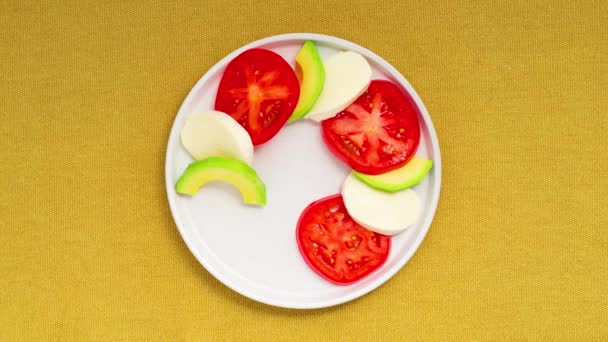 Caprese Salad Tomatoes Mozzarella Cheese Basil Avocado Plate Stop Motion — ストック動画