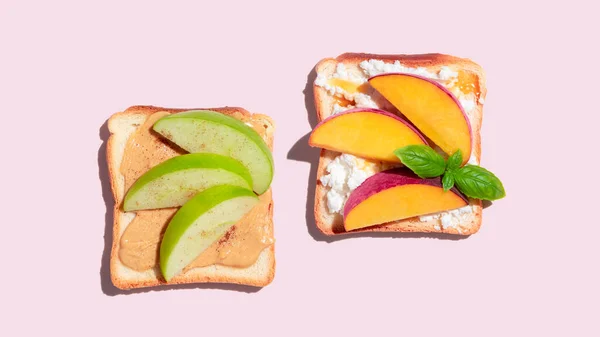 Set of toasted bread with peach and apple on pink background. High quality photo