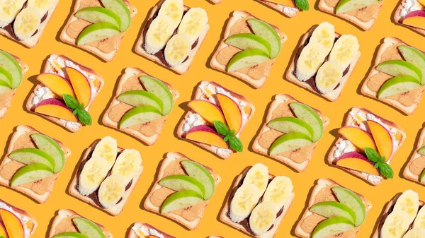 Set of toasted bread with peach, apple and banana on yellow background. Pattern. High quality photo
