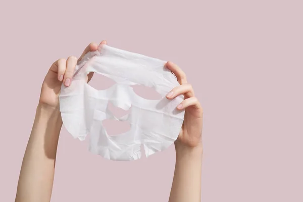 Female Hands Holding Sheet White Mask Pink Background High Quality — Stock Fotó