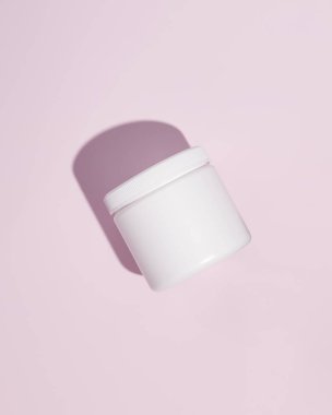 White plastic supplement container on pink background. Package mockup blank for capsule. High quality photo