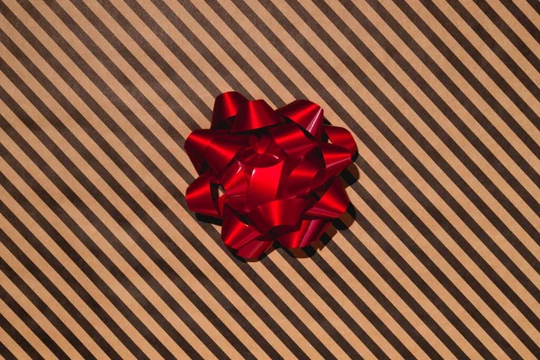 Red gift bow on wrapping paper. High quality photo