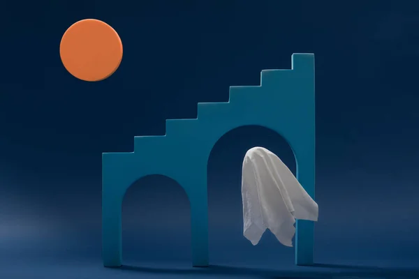 A ghost floats in front of the stairs in the light of the orange moon on blue background. Abstract minimal scary Halloween concept