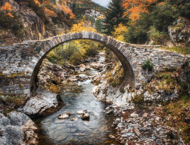 Romanesque bridge of Isaba, Valle de Roncal, Navarre, Spain. A tourist destination famous for cheese production and mountain trails. clipart