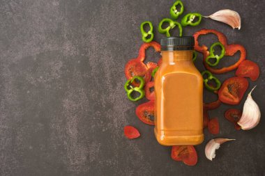 Plastik bir şişede servis edilen Endülüs gazpacho 'su hazır. Götürün. Domates, biber ve arka planda taze sebze çorbası. Etikete metin kopyalamak ve eklemek için boşluk.