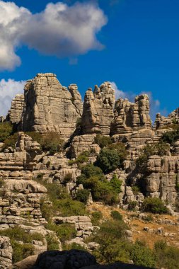 Panoramic view of the famous Torcal de Antequera, Malaga, Spain. Views of the rocky mountains on a sunny day with blue sky in the background and some white clouds. travel concept.