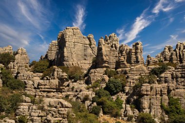 Panoramic view of the famous Torcal de Antequera, Malaga, Spain. Views of the rocky mountains on a sunny day with blue sky in the background and some white clouds. travel concept.