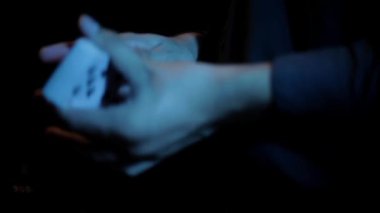 footage of croupier shuffling cards in hands 