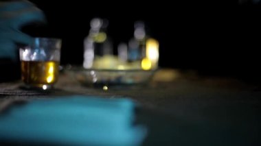 Close up footage of players picking up cards from table in dark dramatic light