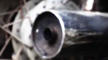 Close-up shot of black-colored exhaust pipe of a bike, HD video.