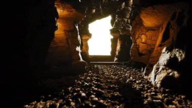 Cinematic shot from inside of a cave with a light source, 3d Render 4K 60FPS.