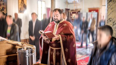 Kilise ayini sırasında dindar bir rahip. Otantik dini tören. Kutsal kitap ve haç. İnanç, umut, ruh ve barış ritüeli. Gerçek hayat sahnesi