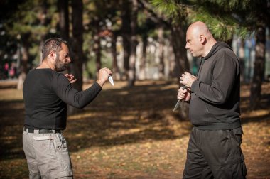 Bıçak, bıçaklı kavgaya karşı. Kapap eğitmenleri sombrada talim metodunu gösteriyor. Silah etkisiz hale getirme tekniği gösterimi