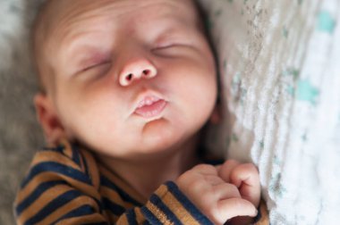 Cute little peaceful baby calm sleeps soundly in his crib in a bright room. Close-up portrait of beautiful child sleeping and resting clipart